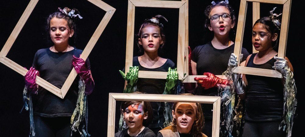 Young performers holding picture frames